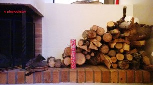 The fire place where a Christmas-themed match box stands