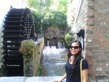 Posing with a watermill in the background