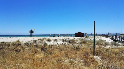 Zahara de los Atunes, with a chiringuito (mini bar) and beach huts and watchtower